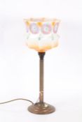 Art Deco copper table lamp, having swirl decorated glass shade, with fluted column and stepped