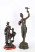 Two 20th century bronzed figurines, one depicting a mother and child the other of a lady, the