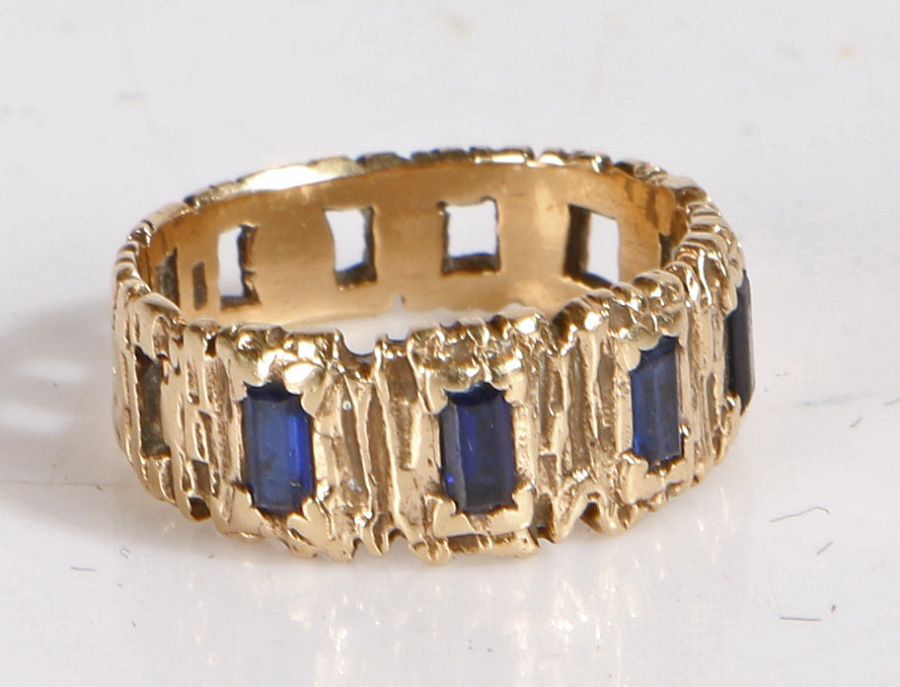 A 9 carat gold and sapphire bark effect ring, set with five baguette cut sapphires, weight 3.4 grams