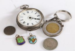 White metal pocket watch set with a white dial and Roman numerals together with three coins and