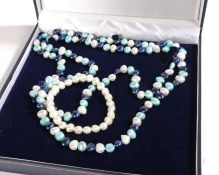 A long multi-layer pearl necklace, comprised of cultured alternating dyed and white pearl, measuring