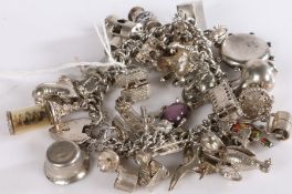 Silver and white metal charm bracelet, charms to include cars, buses, compass, animals etc, gross