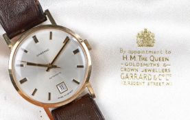Garrard 9 carat gold gentleman's wristwatch, the signed silver dial with baton markers and date