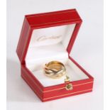 A Cartier Trinity ring, in 18 carat white, yellow and rose gold, signed Cartier, dated 1997, 13.6