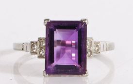 18 carat white gold, platinumed amethyst ring, the rectangular faceted amethyst flanked by three