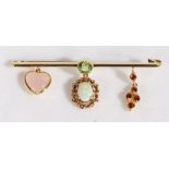 A delightful 15 carat gold and multi-gem bar brooch, having a round cut peridot to the centre of the