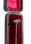 An elegant stick pin with twist detailing, surmounted by a stalking bear, weight 1.77 grams.