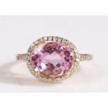 18 carat gold and kunzite ring, having an oval cut kunzite to the centre, weighing 4.46 carats and a