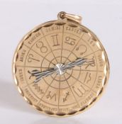 9 carat gold 35mm diameter circular zodiac pendant, with white gold rotating pointer and