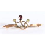 Unmarked gold coloured metal brooch, the central amethyst flanked by two peridot suspended from a