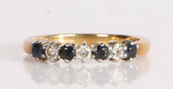 An 18 carat gold diamond and sapphire set ring, the head with four sapphires and three diamonds, 2.6