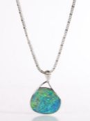 A modern 18 carat gold and black opal pendant necklace, the pendant is comprised of an opal slice