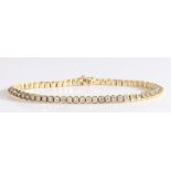 18 carat gold tennis bracelet, with 64 brilliant cut diamonds adding up to an approximate weight