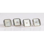 Four art deco 9 carat white gold and diamond collar studs, set with a central brilliant cut