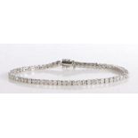 An elegant 9 carat white gold and diamond tennis bracelet, set throughout with round brilliant cut