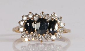 9 carat gold and gem set cluster ring, having three graduated oval cut stones to the centre