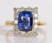 18 carat gold, sapphire and diamond ring, the central facet cut sapphire surrounded by a rectangle