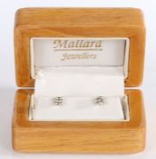 A classic pair of 18 carat white gold and diamond stud earrings, each at approximately 0.25 carat