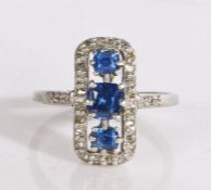 Platinum and 18 carat gold sapphire and diamond ring, comprised of a line of three claw set blue