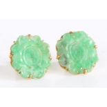 A pair of unusual unmarked high carat mounted carved jade earrings, the foliate carved jade heads