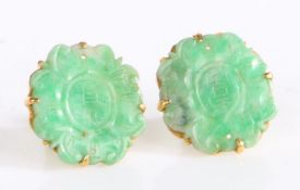 A pair of unusual unmarked high carat mounted carved jade earrings, the foliate carved jade heads