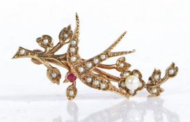 9 carat gold, ruby and seed pearl brooch, in the form of a bird amongst floral sprays, 38.5mm
