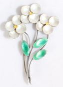 A silver and enamel flower brooch, comprised of three elegant silver stems each with a yellow and