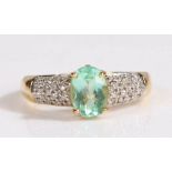 18 carat gold and Paraiba tourmaline ring, the central oval cut 1 carat Paraiba tourmaline set in an