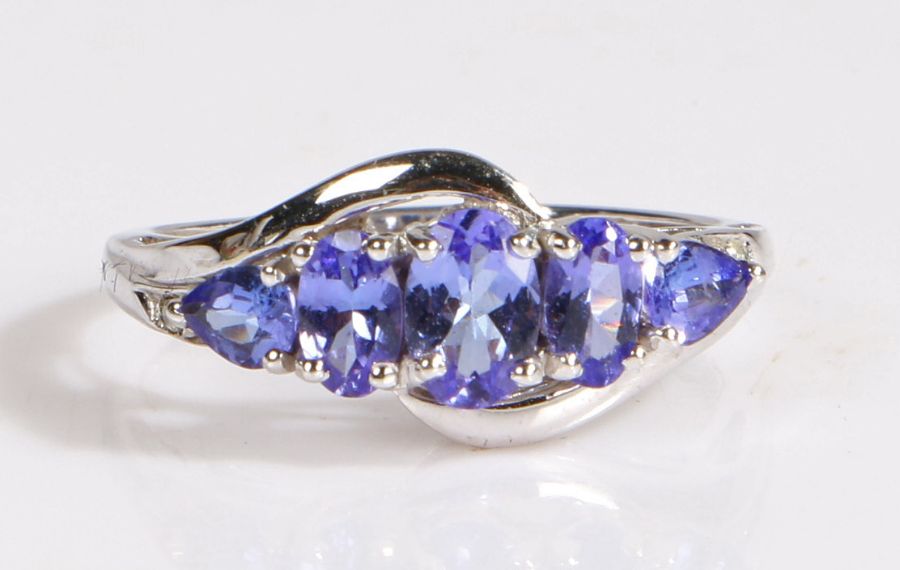 A 14 carat white gold and tanzanite ring, the head set with five tanzanite stones, ring size O