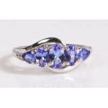 A 14 carat white gold and tanzanite ring, the head set with five tanzanite stones, ring size O