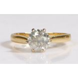 An 18 carat gold and diamond solitaire ring, the heads set with a claw mounted brilliant cut diamond