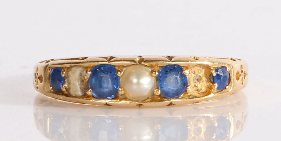 A Victorian 18 carat gold sapphire and pearl ring, assayed Birmingham 1887, with four sapphires