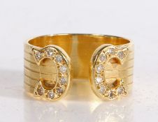 18 carat gold and diamond ring, the reeded open band terminating in two diamond set horseshoes, ring