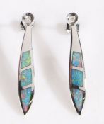 A pair of 14 carat white gold and black opal pendant earrings, each pendant comprised of three