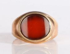 A 19th Century oval cut carnelian ring, set across the width of the ring in a raised mount, 4.09