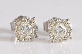 Pair of 10 carat white gold diamond cluster ear studs, with a central round cut diamond and