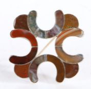 Unmarked Scottish white metal hardstone set brooch, formed from four conjoined scrolls, 57.5mm wide,
