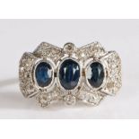 White metal diamond and topaz plaque ring, having three graduated oval cut topaz stones framed by an