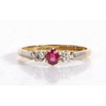 18 carat platinum set ruby and diamond ring, the central ruby flanked by two diamonds, ring size
