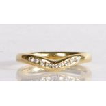 An 18 carat gold diamond set ring, with nine diamonds to the arched shank head, 3.8 grams, ring size