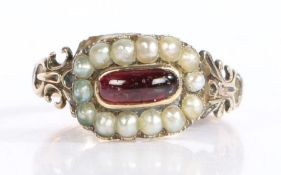 Antique seed pearl and garnet set memorial ring, the central oval garnet surrounded by a band or