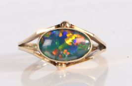 A black opal set ring, the cabochon cut triplet opal set to angled shoulders, 4.2 grams, ring size