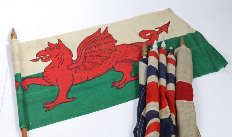 A selection of Early 20th century British patriotic flags, printed on bunting material, mounted on