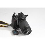 Nikon D3000 camera with Nikon AF NIKKOR 70-300mm 1:4-5.6G lens and battery grip