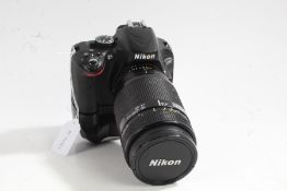 Nikon D5100 camera with Nikon AF NIKKOR 70-210mm 1:4-5.6 lens and battery grip