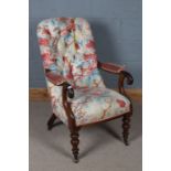 Victorian mahogany and upholstered nursing chair, having a floral button back and scroll arms raised