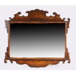 George III style walnut wall mirror, with scroll fret frame surrounding the rectangular mirror