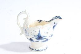 A Derby porcelain creamer, circa 1775, decorated in blue and white with a pagoda above a