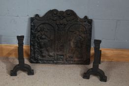 Heavy cast iron fire back, centred with with two figures, 64cm wide, 59cm high, with a pair of