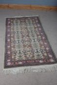 Persian style rug, the cream ground decorated with floral designs and multiple borders and tassel